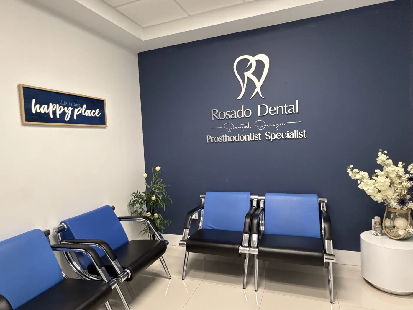 Miami clinic lobby with the Rosado Dental sign on a navy wall and modern blue and chrome chairs